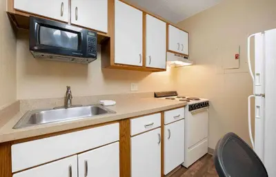 a small kitchen with a sink and a microwave at Studio 6 Extended stay Fairfield, OH - Cincinnati in Fairfield