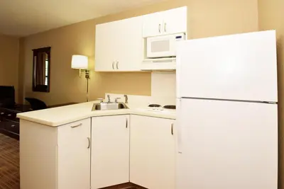 a kitchen with white cabinets and a white refrigerator at Studio 6 Extended stay Fairfield, OH - Cincinnati in Fairfield