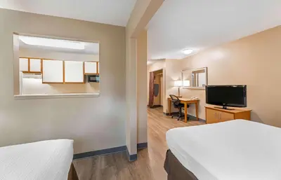 a hotel room with two beds and a flat screen tv at Extended Stay America Suites - Cleveland - Westlake in Westlake