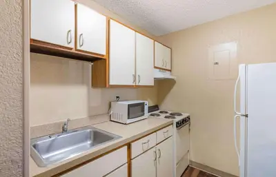 a small kitchen with a sink and a microwave at Extended Stay America Suites - Toledo - Maumee in Maumee