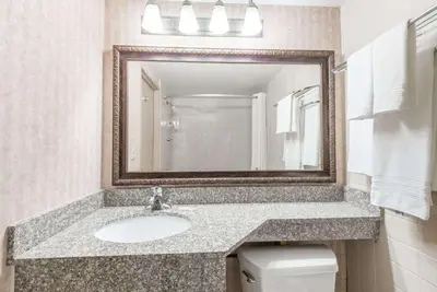 a bathroom with a sink and a mirror at Days Inn by Wyndham Niles in Niles