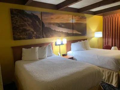 a hotel room with two beds and a painting on the wall at Days Inn by Wyndham Niles in Niles