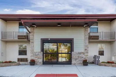 a building with a large door and a balcony at Red Roof Inn Richmond, IN in Richmond