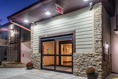 an entrance to a building with a exit sign on it at Red Roof Inn Richmond, IN in Richmond