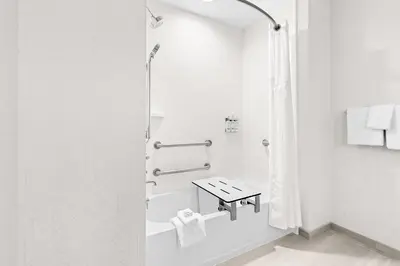 a white bathroom with a shower and a sink at Holiday Inn Express Washington Court House by IHG in Washington Court House