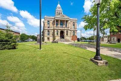 a building with a clock tower on a field of grass at Holiday Inn Express Washington Court House by IHG in Washington Court House