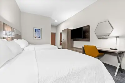 a hotel room with two beds and a desk at Holiday Inn Express Washington Court House by IHG in Washington Court House