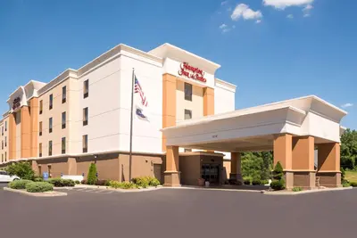 a hotel with an american flag in front of it at Hampton Inn & Suites Mansfield South @ I 71 in Mansfield