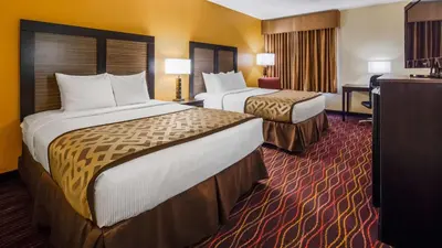 a hotel room with two beds and a desk at Best Western B R Guest in Zanesville