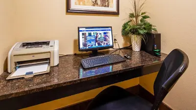 a desk with a computer and a printer on it at Best Western B R Guest in Zanesville