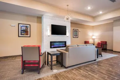 a living room with a fireplace and a tv at Comfort Suites Marysville Columbus - Northwest in Marysville