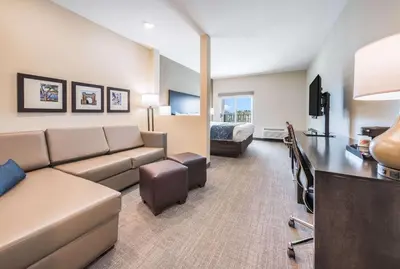 a living room with a couch and a bed at Comfort Suites Marysville Columbus - Northwest in Marysville
