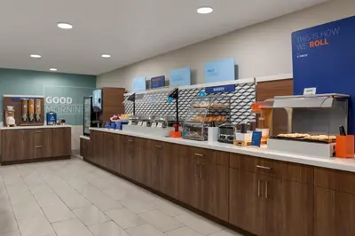 a bakery with a counter with donuts on it at Holiday Inn Express & Suites North Fremont by IHG in Fremont