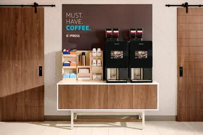 a coffee shop with a counter with a coffee maker on it at Holiday Inn Express & Suites North Fremont by IHG in Fremont