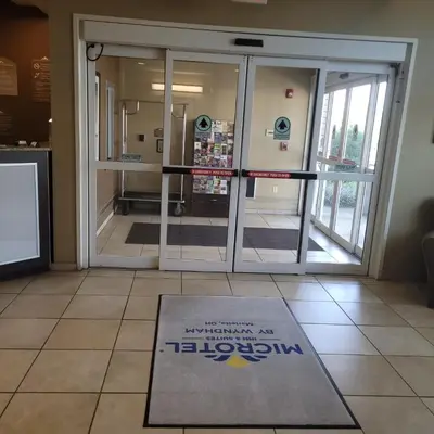 a door with a welcome mat in front of it at Microtel Inn & Suites by Wyndham Marietta in Marietta