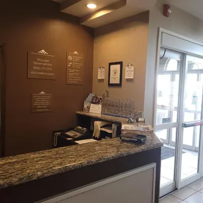 a restaurant with a counter with a phone on it at Microtel Inn & Suites by Wyndham Marietta in Marietta