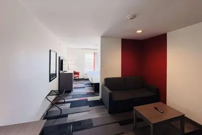 a living room with a couch and a table at Ramada by Wyndham Sparta/At Speedway in Sparta