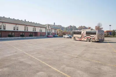 an rv parked in a parking lot next to a building at Super 8 by Wyndham Grayson in Grayson