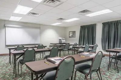 a classroom with tables and chairs and a whiteboard at Super 8 by Wyndham Grayson in Grayson