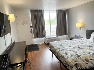 a hotel room with a bed and a desk and a window at Motel 6-Troy, OH in Troy