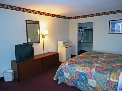 a hotel room with a bed and a television at Motel 6-Troy, OH in Troy