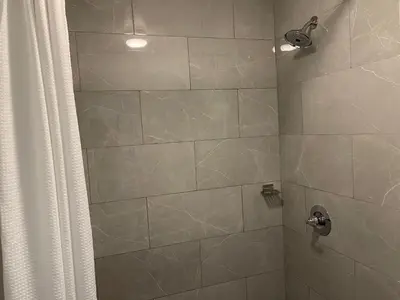 a bathroom with a shower with a shower curtain at Motel 6-Troy, OH in Troy