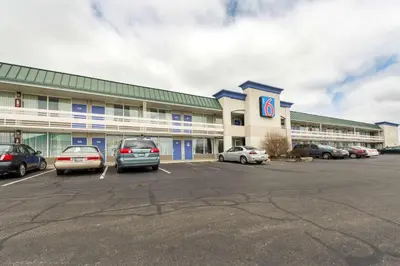 a large building with cars parked in a parking lot at Motel 6-Troy, OH in Troy