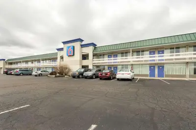 a large building with cars parked in a parking lot at Motel 6-Troy, OH in Troy
