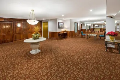 a lobby with a waiting room with a table and chairs at Quality Inn & Suites Cincinnati I-275 in Springdale
