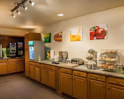 a large kitchen with a counter with food on it at Quality Inn & Suites Cincinnati I-275 in Springdale