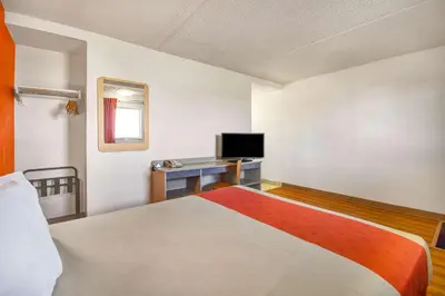 a room with a bed and a desk with a television at Motel 6-North Ridgeville, OH - Cleveland Intl Airport - N Ridgeville in North Ridgeville