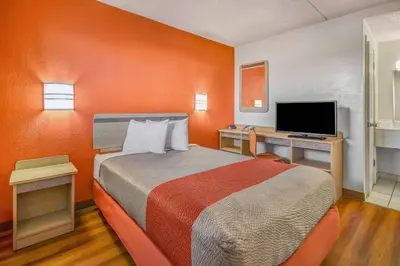 a room with a bed and a desk with a television at Motel 6-North Ridgeville, OH - Cleveland Intl Airport - N Ridgeville in North Ridgeville