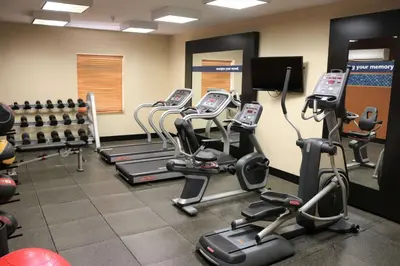 a gym with rows of exercise bikes and tread machines at Hampton Inn & Suites Fremont in Fremont