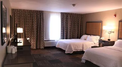a hotel room with two beds and a window at Hampton Inn & Suites Fremont in Fremont