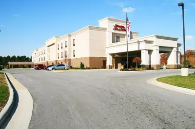 an empty street in front of a building with a flag at Hampton Inn & Suites Fremont in Fremont