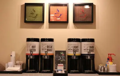 a group of four bottles of hair products on a shelf at Hampton Inn & Suites Fremont in Fremont