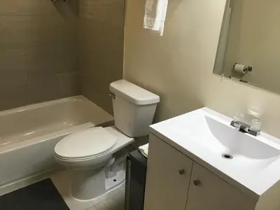 a bathroom with a white toilet and a sink at Bellevue Hotel and Suites in Bellevue