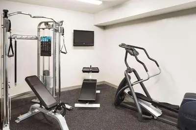 a gym with two exercise bikes and a tv at Country Inn & Suites by Radisson, Columbus Airport, OH in Columbus
