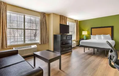 a hotel room with a bed and a couch at Extended Stay America Suites - Columbus - Tuttle in Dublin