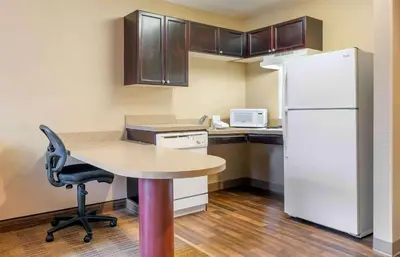 a small kitchen with a table and a refrigerator at Extended Stay America Suites - Columbus - Tuttle in Dublin