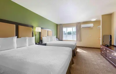 a hotel room with two beds and a television at Extended Stay America Suites - Pittsburgh - Airport in Imperial