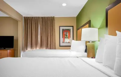 a hotel room with two beds and a television at Extended Stay America Suites - Pittsburgh - Airport in Imperial