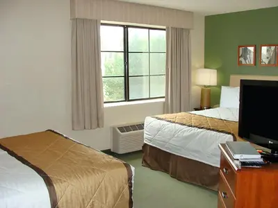 a hotel room with two beds and a television at Extended Stay America Suites - Pittsburgh - Airport in Imperial