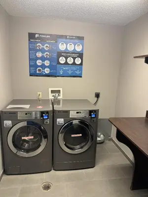 a laundry room with a washer and a dryer at Microtel Inn & Suites by Wyndham Wheeling at The Highlands in Triadelphia