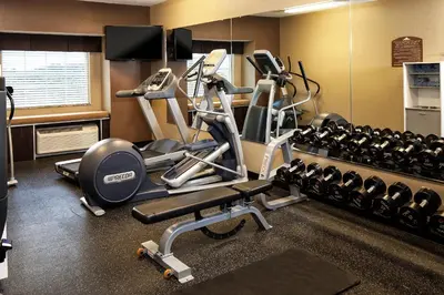a gym with cardio equipment in a hotel room at Microtel Inn & Suites by Wyndham Wheeling at The Highlands in Triadelphia