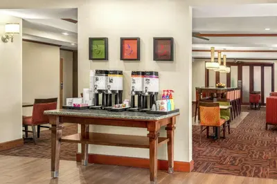 a lobby with a table with coffee makers on it at Hampton Inn Athens in Athens