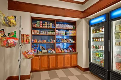 a kitchen with a refrigerator and some food at Hampton Inn Athens in Athens