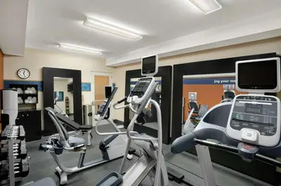 a gym with several tread machines and a treadmill at Hampton Inn Athens in Athens