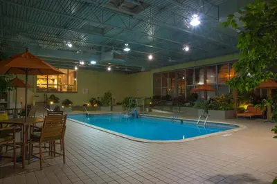 a large pool with a table and chairs in a building at Holiday Inn Portsmouth Downtown by IHG in Portsmouth