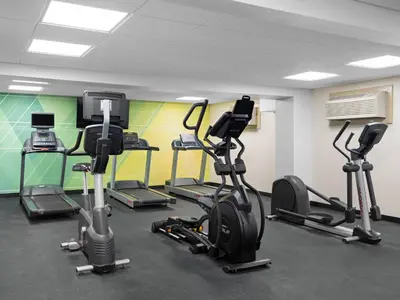 a gym with several treadmills and exercise bikes at Holiday Inn Portsmouth Downtown by IHG in Portsmouth